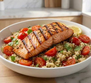 Grilled salmon and quinoa bowl with cherry tomatoes